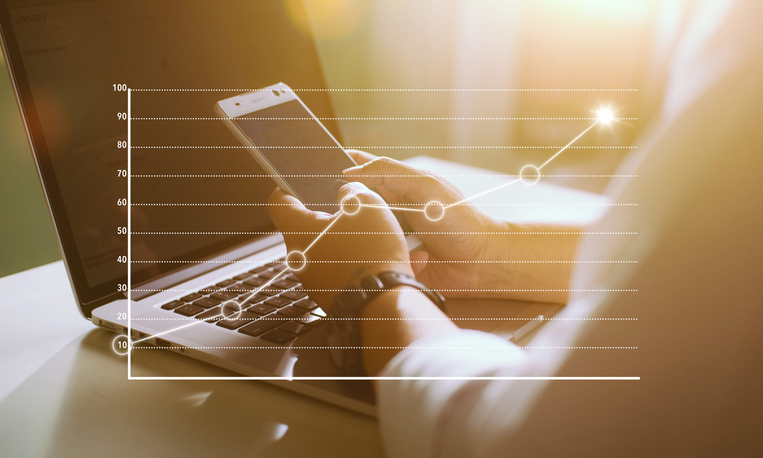 businessman-using-smart-phone-and-laptop-with-graph-statistical-analysis-business-succ-SBI-301985308